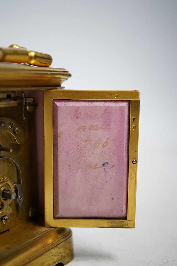 A miniature brass and enamel figurative panelled carriage timepiece, 7cm high. Condition - both gilt and enamel panels marked